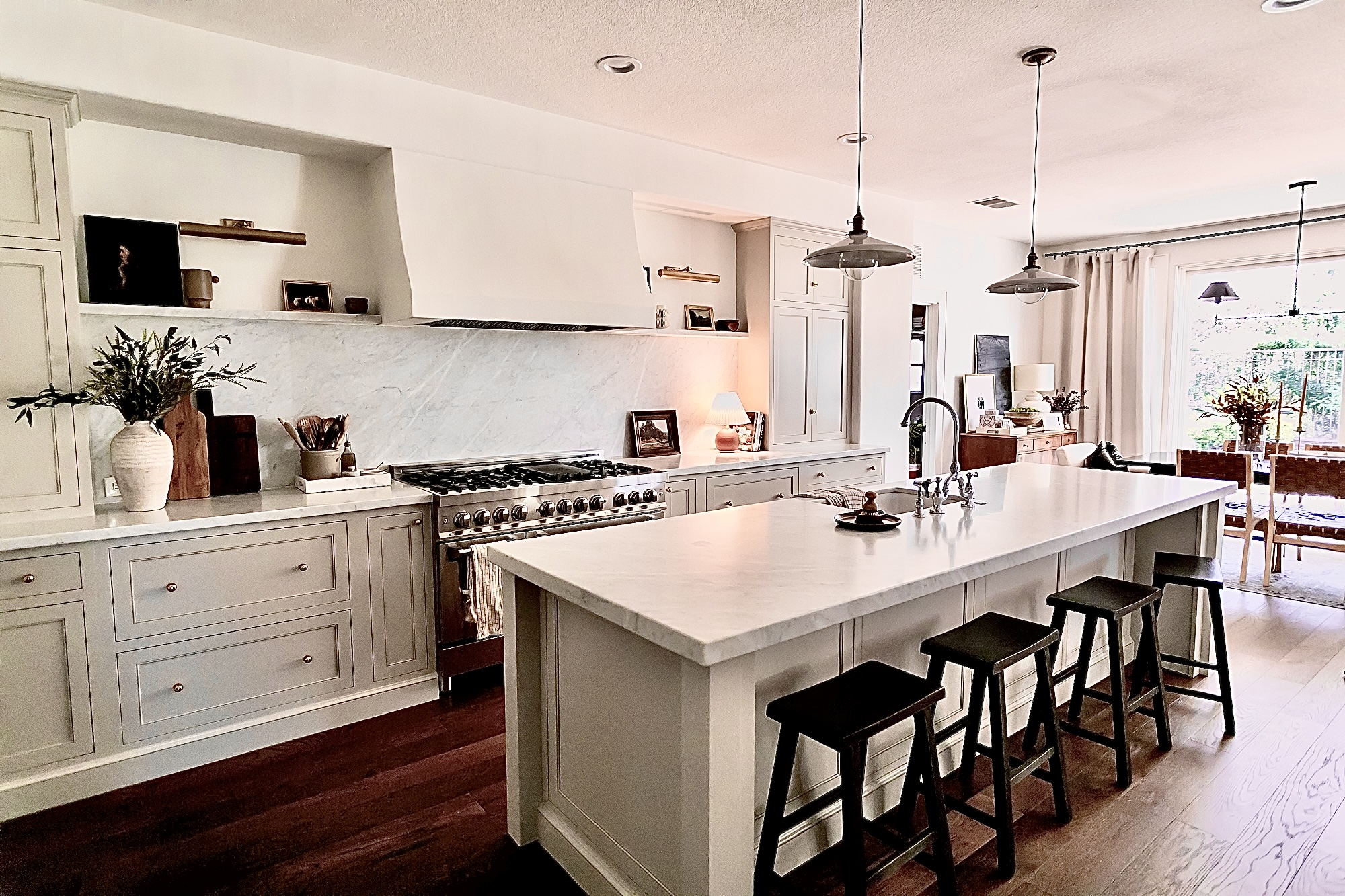 Custom kitchen remodel with gray-green cabinets, marble island, and brass hardware by J. Arthur Custom Homes